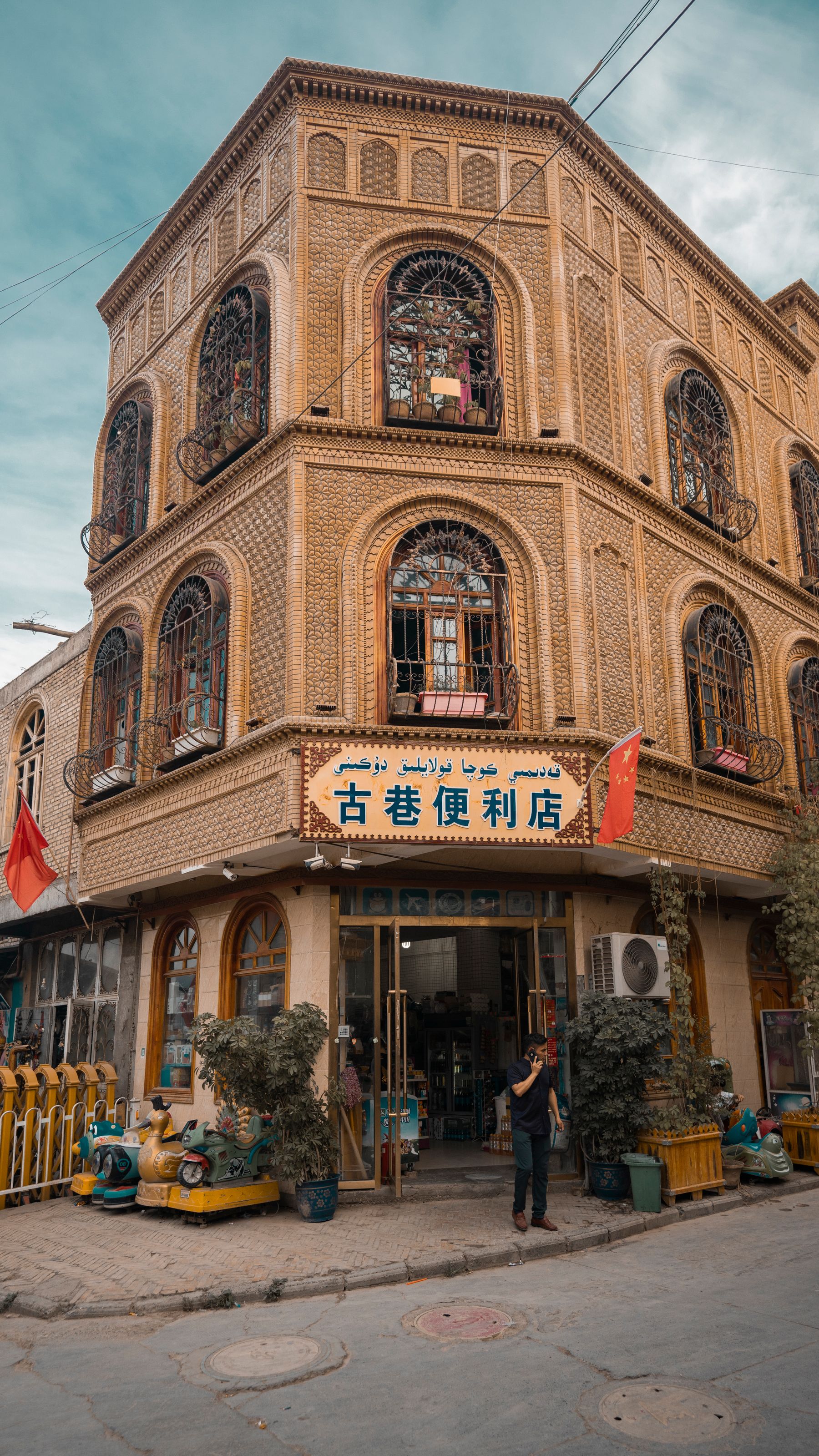 Carved wooden windows and patterned brick facade of a traditional Kashgar building, Xinjiang
